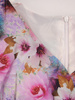 Kopertowa sukienka z wyszczuplającą baskinką Sabira, wiosenna kreacja w kwiaty.